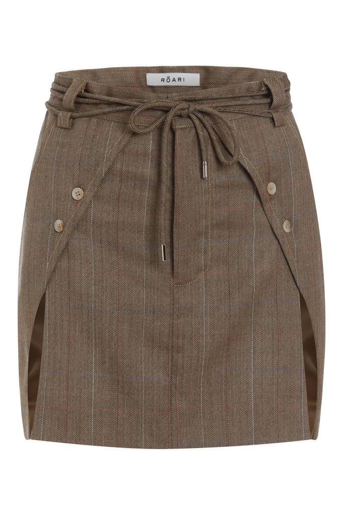 Camel Herringbone Ronnie Skirt Paneled skirt featuring a self-fabric waist tie tunneled through two rows of belt loops. Double front vents are secured by horn buttons. Slightly lengthened back for added coverage. 