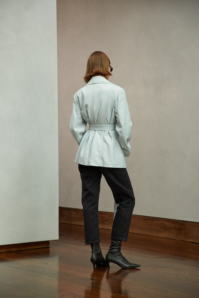 Powder Blue Kennedy Jacket This vintage inspired leather jacket offers a structured look with sharp collars and light shoulder pads. Includes double wrap belt for a customized look. Available in Black glazed cow leather and a Powder Blue vegan leather.Style with The Sarah Jean | The Zoey Tee