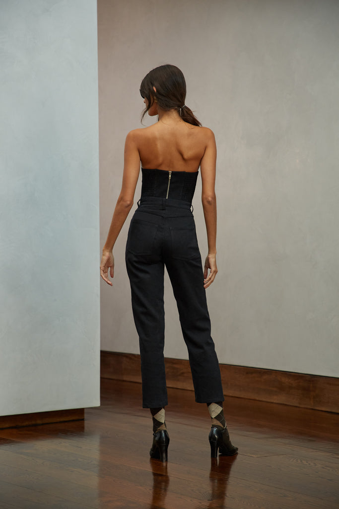 Jet Black Sarah Stretch Jean Vintage inspired high-rise fit with a relaxed straight-leg in a lightweight stretch denim, cropped ankle length and seams down the front. Each hand-finished pair has a branded enameled button. Made in New York.  Brittany is 5'10