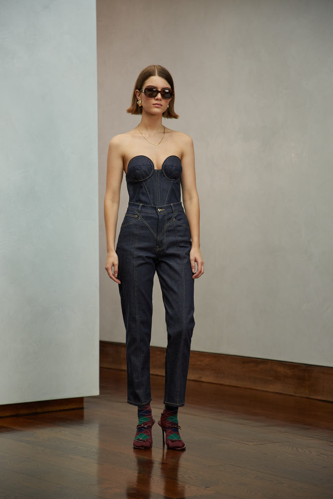 Raw Indigo Sarah Stretch Jean Vintage inspired high-rise fit with a relaxed straight-leg in a lightweight stretch denim, cropped ankle length and seams down the front. Each hand-finished pair has a branded enameled button. Made in New York.  Brittany is 5'10