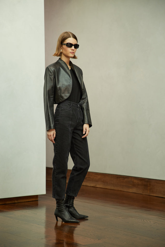 Black Saint Bolero This cropped bolero-style jacket is cut from luxurious Italian leather. It features an open front, internal zip-pocket, and shoulder pads for added structure.