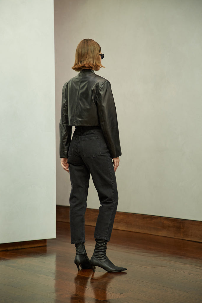 Black Saint Bolero This cropped bolero-style jacket is cut from luxurious Italian leather. It features an open front, internal zip-pocket, and shoulder pads for added structure.