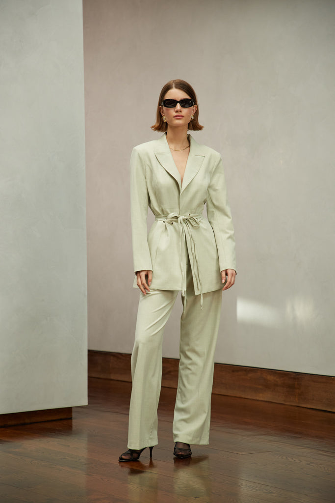 Sage Kat Trouser Dual pleated mid-rise trousers featuring a straight, relaxed fit. Pockets at back with horn buttons. Includes a self-fabric detachable belt. Style with The Rhodes Blazer  | Also available in BlackThis item is FINAL SALE.