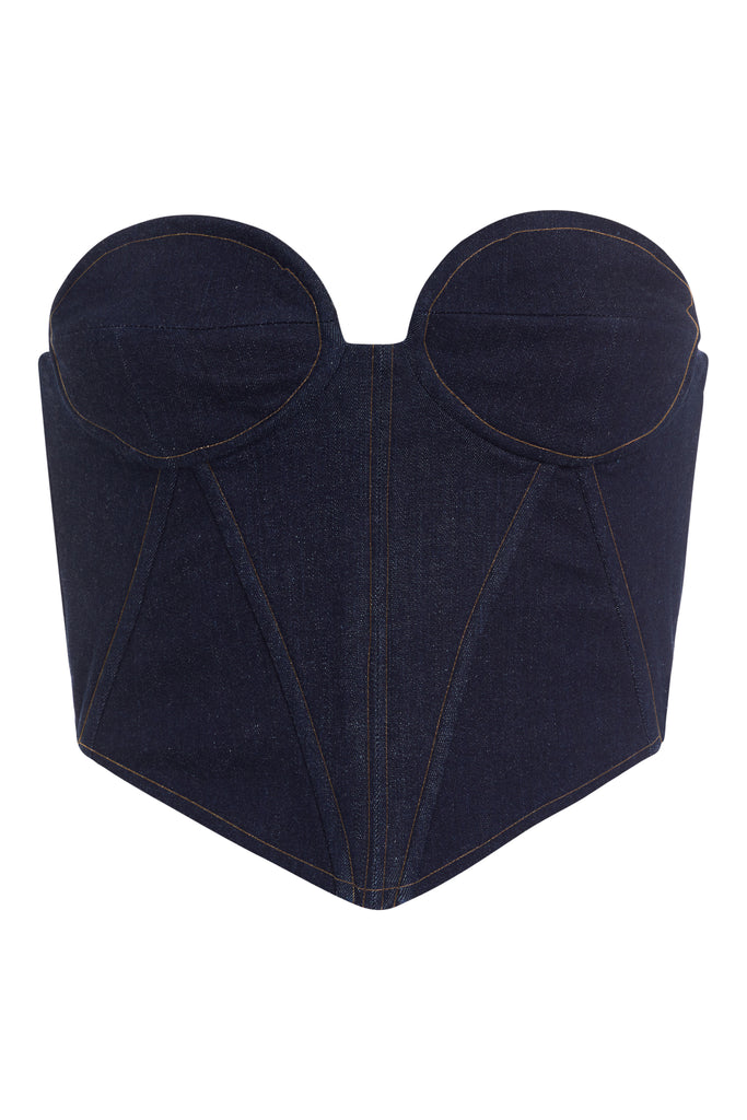 Raw Indigo Chloe Corset This strapless corset features a fitted denim bodice with contoured boning, moldable wiring at cups, and shirred back panels to ensure a snug yet flexible fit. Slightly cropped with a v-front silhouette.
