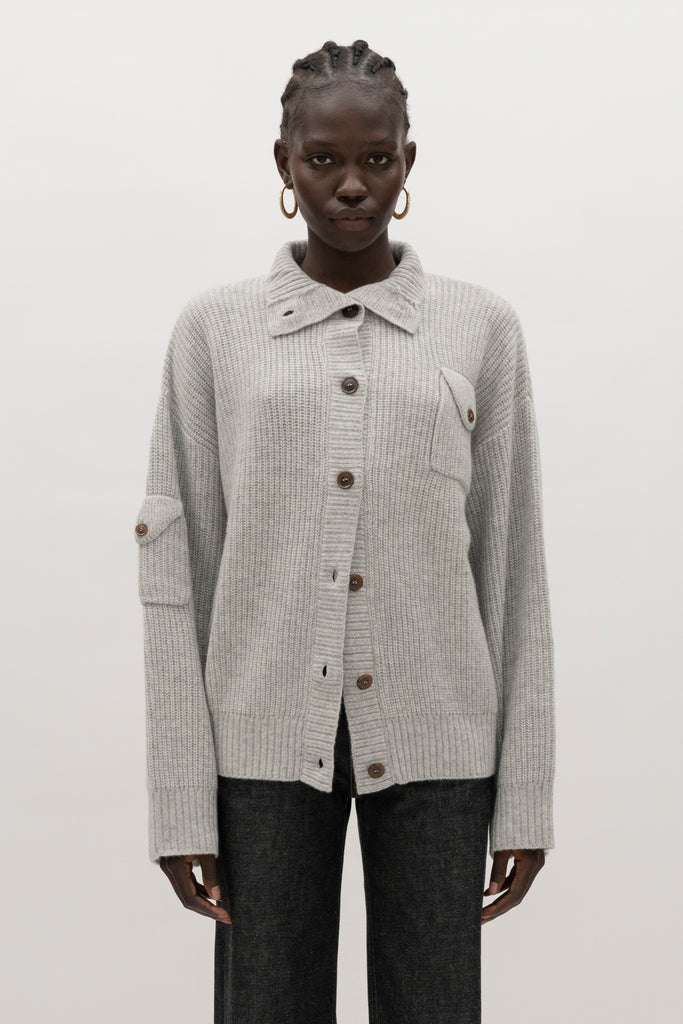 Heather Grey Graham Cardigan This 100% royal cashmere cardigan features an oversized silhouette that hits below the hip, perfect for layering. Features horn buttons along with pockets at chest and right sleeve. Can be worn open or buttoned up as a turtleneck.We recommend ordering your usual size.Styled with the Jane Jean