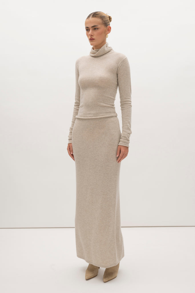 Oatmeal Ava Skirt Delicately soft and consciously crafted, the perfect foundation for creating effortless looks.-Classic maxi skirt silhouette-Full length-Slit at center back-Elastic waistband 🐑 Made with Good Cashmere Standard® wool to support the welfare of cashmere goats We recommend ordering your usual size.Styled with the Olivia Turtleneck & Vivien LS Top