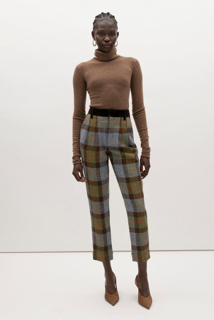 Green Multi Plaid Raymond Trouser Expertly tailored in a silhouette that echoes the collection's blend of classic tailoring and modern details.-100% British wool, handwoven in the Western Isles of Scotland-Straight leg ankle length trouser-Smooth velvet combo waistband-Double-pleated front-Slant front pockets-Self-doubled belt loops-Zip fly with hook and bar closure-Faux welt back pockets-Fully lined for superior comfort and drape♻️ Minimizing our environmental impact: Harris Tweed is naturally renewable, biodegradable and recyclable.We recommend ordering your usual size.Styled with the Raymond Jacket & Olivia Turtleneck 