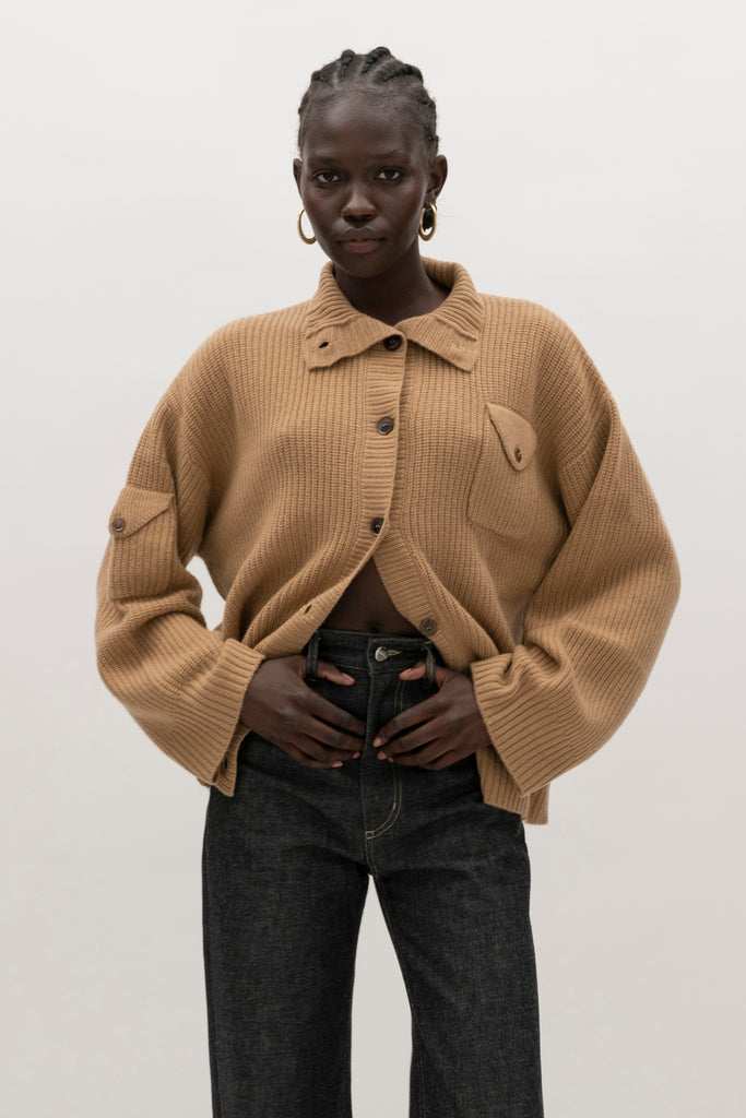 Creme Brulee Graham Cardigan This 100% royal cashmere cardigan features an oversized silhouette that hits below the hip, perfect for layering. Features horn buttons along with pockets at chest and right sleeve. Can be worn open or buttoned up as a turtleneck.We recommend ordering your usual size.Styled with the Jane Jean