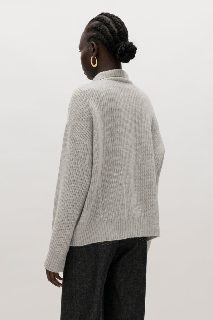 Heather Grey Graham Cardigan This 100% royal cashmere cardigan features an oversized silhouette that hits below the hip, perfect for layering. Features horn buttons along with pockets at chest and right sleeve. Can be worn open or buttoned up as a turtleneck.We recommend ordering your usual size.Styled with the Jane Jean