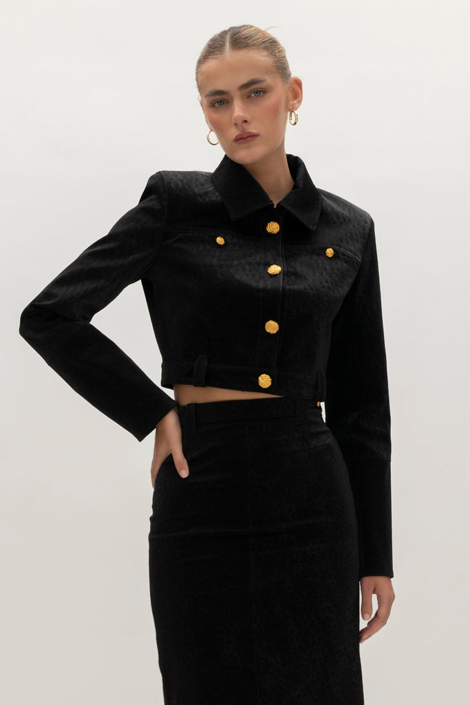 Black Ostrich Meredith Jacket A fresh take on the classic suit jacket, this faux ostrich piece features ROARI's signature gold knot buttons at center front, welt pockets and cuffs. Fully lined.We recommend ordering your usual size.Styled with the Meredith Skirt