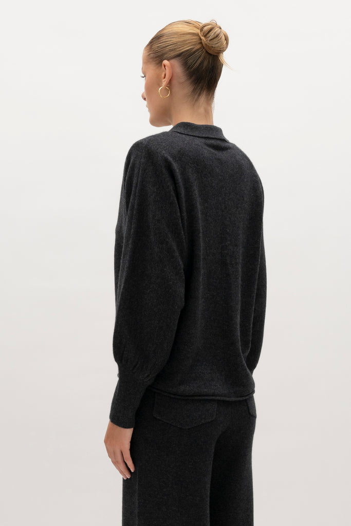 Charcoal Nico Shirt A seamless blend of soft comfort, style, and conscious sourcing, creating an essential you'll reach for again and again. -Collared open cardigan-Single hook and eye closure-Rib knit collar-Tailored ribbed cuffs-Dolman sleeves-Hip length-Rolled bottom hem-Self covered removable shoulder pads🐑 Made with Good Cashmere Standard® wool to support the welfare of cashmere goats We recommend ordering your usual size.Styled with the Beverly Trouser