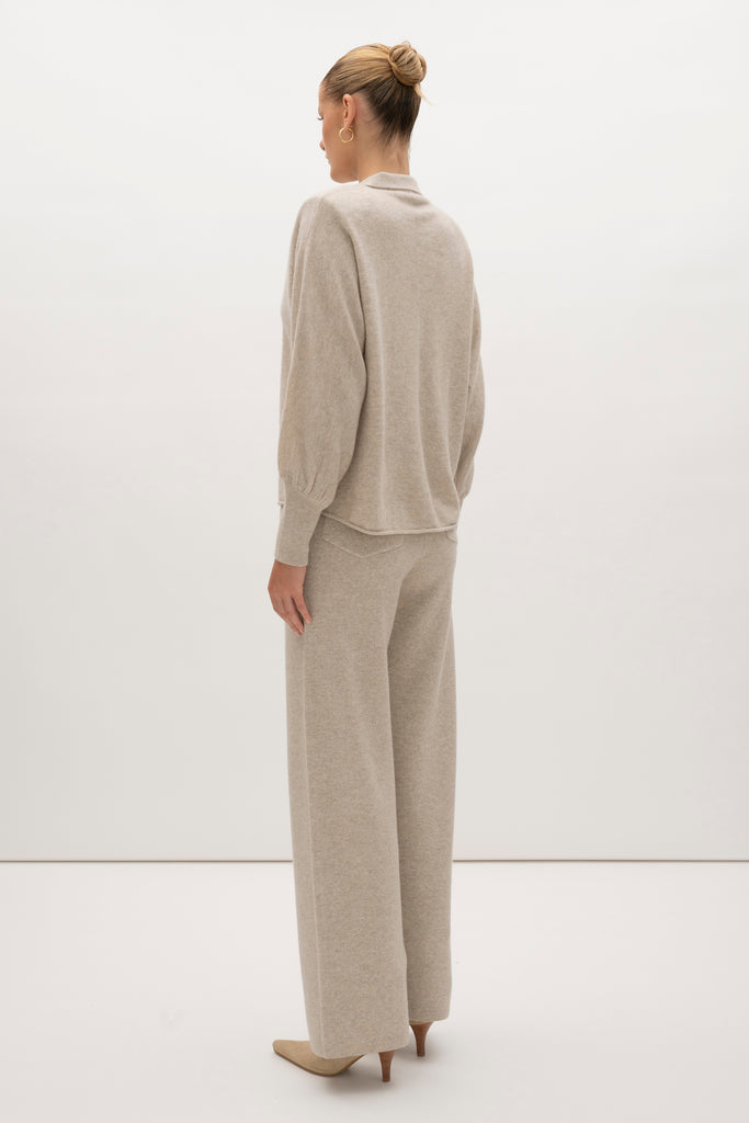 Oatmeal Nico Shirt A seamless blend of soft comfort, style, and conscious sourcing, creating an essential you'll reach for again and again. -Collared open cardigan-Single hook and eye closure-Rib knit collar-Tailored ribbed cuffs-Dolman sleeves-Hip length-Rolled bottom hem-Self covered removable shoulder pads🐑 Made with Good Cashmere Standard® wool to support the welfare of cashmere goats We recommend ordering your usual size.Styled with the Beverly Trouser