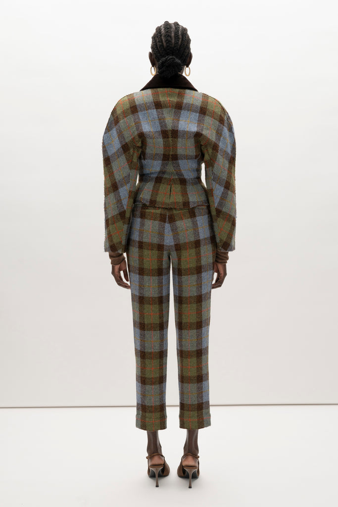 Green Multi Plaid Raymond Jacket A sophisticated and heritage-inspired piece crafted from authentic Harris Tweed, featuring a distinctive double-breasted design and unique textural details.-100% British wool, handwoven in the Western Isles of Scotland-High performance durable and windproof fabric-Double-breasted front closure-Peplum waist detail-Dolman sleeves-Brown velvet contrasting collar-Raw edges at lapel and center front placket-Decorative gold knot button closure-Fully lined♻️ Minimizing our environmental impact: Harris Tweed is naturally renewable, biodegradable and recyclable.We recommend ordering your usual size.Styled with the Raymond Trouser, Kate Short, & Olivia Turtleneck 