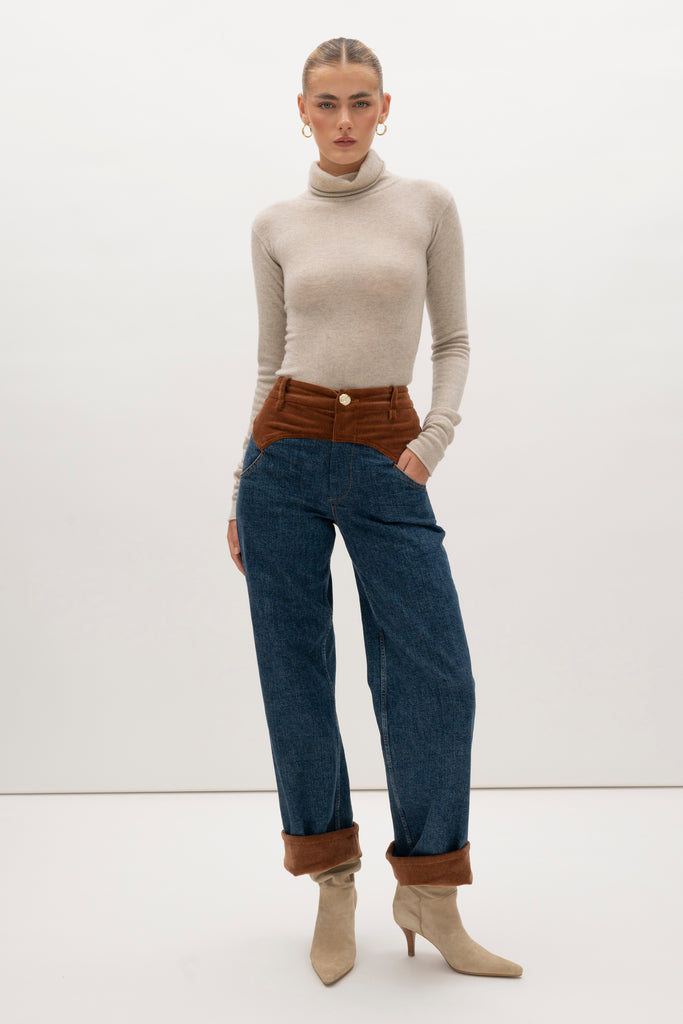 Medium Indigo Torrey Jean Featuring combination fabrics and crafted from premium Japanese denim, these novelty pants elevate the classic wide-leg silhouette with unexpected details.-Premium Japanese denim -Signature corset style waistband in contrasting corduroy fabric -Wide leg-Flannel-lined at waist -Corduroy faced cuffs at bottom hem -Pockets at front and back-Gold knot button closure -Zip-fly ♻️ Environmentally conscious: Made with up-cycled Japanese denim that is produced with reduced CO2 emissions and water-conserving processes. We recommend ordering your usual size.Styled with the Torrey Jacket & Olivia Turtleneck 