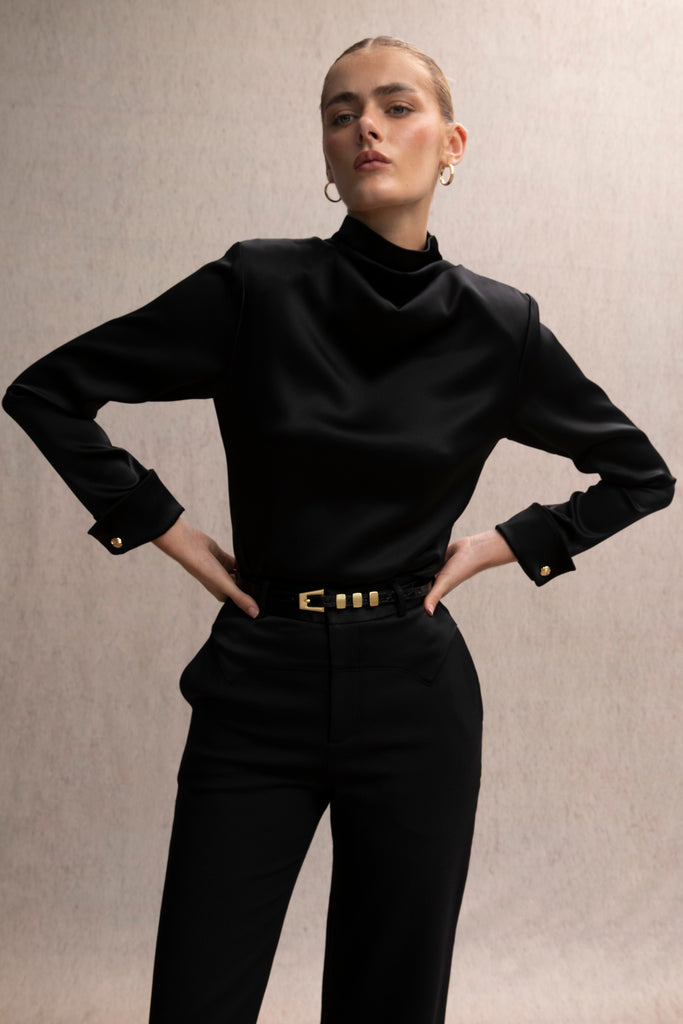 black Mia Trouser The Mia trouser: Expertly tailored in a silhouette that echoes the collection's blend of classic tailoring and modern details.-Relaxed leg trouser -Corset style satin contrast waistband-Zip fly with hook and eye closure-Self-doubled belt loops -Tailored fit with fluid drape-On seam front pockets -Faux welt back pockets -Two inch seam allowance at hem We recommend ordering your usual size.Styled with the Vivien LS Top