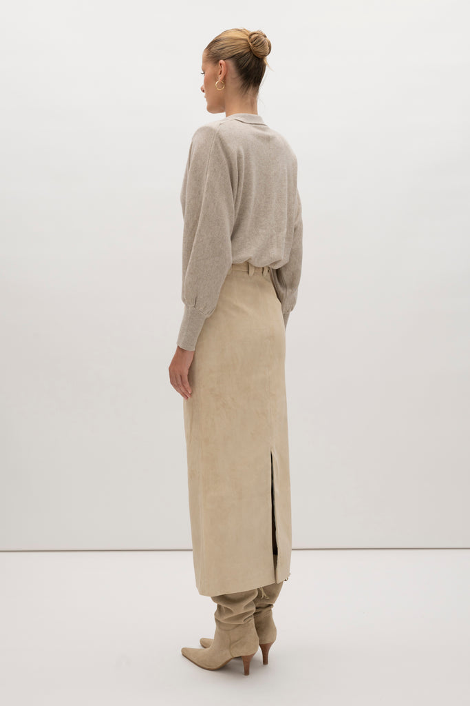 Sand Meredith Skirt -Vintage inspired pencil skirt, fitted through waist and hips-100% calf leather (suede) -Darts at front and back for a sculpted fit-Clean-finished waistband with interior facing and under-stitching-Invisible side zipper with ornate button closure at waistband-Self-doubled belt loops reinforced with strong bar tacks-Back vent for movement -Fully linedWe recommend ordering your usual size.Styled with the Hyde Jacket