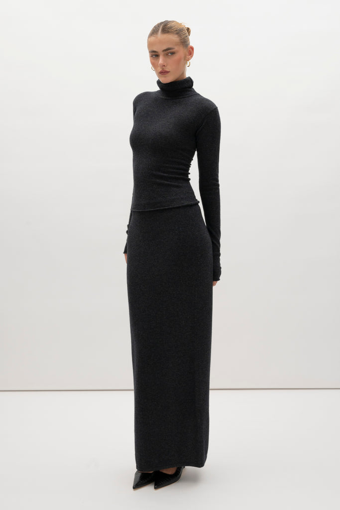 Charcoal Olivia Turtleneck Delicately soft and consciously crafted, it's the perfect foundation for any outfit.-Classic turtleneck silhouette -Extra-long neck trim for versatile styling (folding and stacking)-Long sleeves designed for slight stacking at the wrist-Rolled wrist and bottom hem 🐑 Made with Good Cashmere Standard® wool to support the welfare of cashmere goats We recommend ordering your usual size.Styled with the Ava Skirt