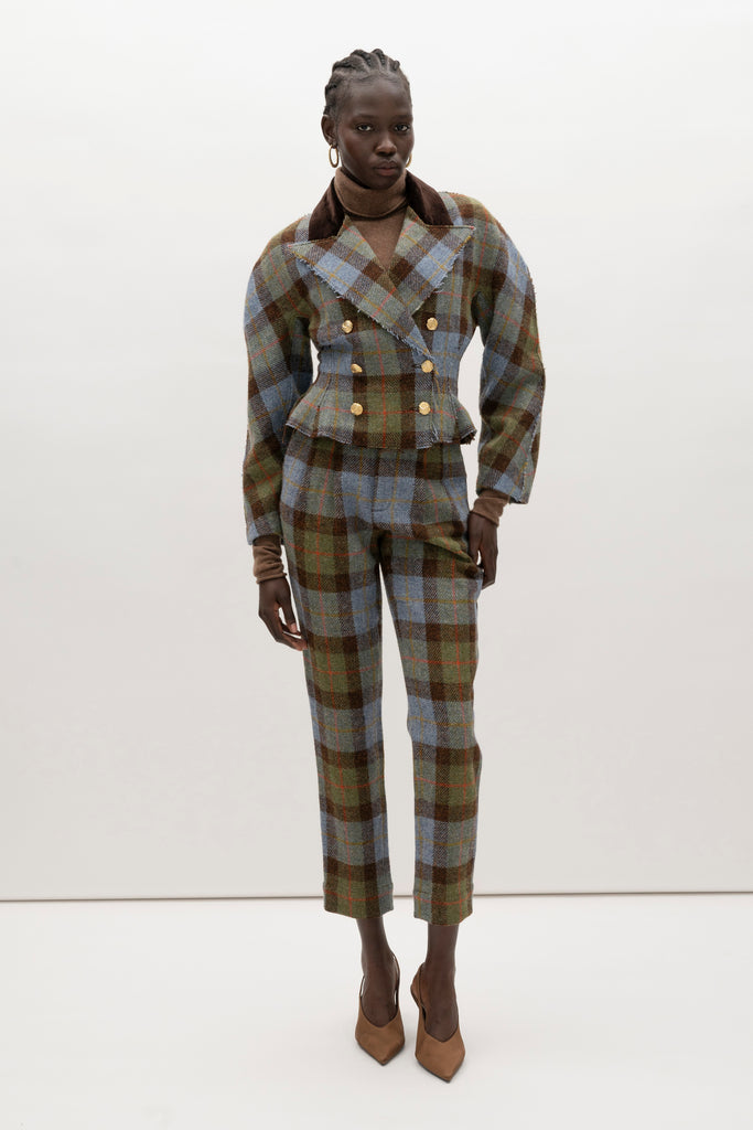 Green Multi Plaid Raymond Jacket A sophisticated and heritage-inspired piece crafted from authentic Harris Tweed, featuring a distinctive double-breasted design and unique textural details.-100% British wool, handwoven in the Western Isles of Scotland-High performance durable and windproof fabric-Double-breasted front closure-Peplum waist detail-Dolman sleeves-Brown velvet contrasting collar-Raw edges at lapel and center front placket-Decorative gold knot button closure-Fully lined♻️ Minimizing our environmental impact: Harris Tweed is naturally renewable, biodegradable and recyclable.We recommend ordering your usual size.Styled with the Raymond Trouser, Kate Short, & Olivia Turtleneck 