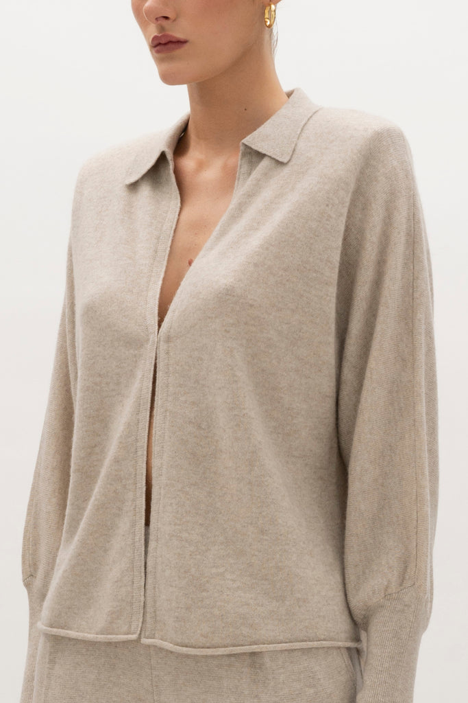 Oatmeal Nico Shirt A seamless blend of soft comfort, style, and conscious sourcing, creating an essential you'll reach for again and again. -Collared open cardigan-Single hook and eye closure-Rib knit collar-Tailored ribbed cuffs-Dolman sleeves-Hip length-Rolled bottom hem-Self covered removable shoulder pads🐑 Made with Good Cashmere Standard® wool to support the welfare of cashmere goats We recommend ordering your usual size.Styled with the Beverly Trouser