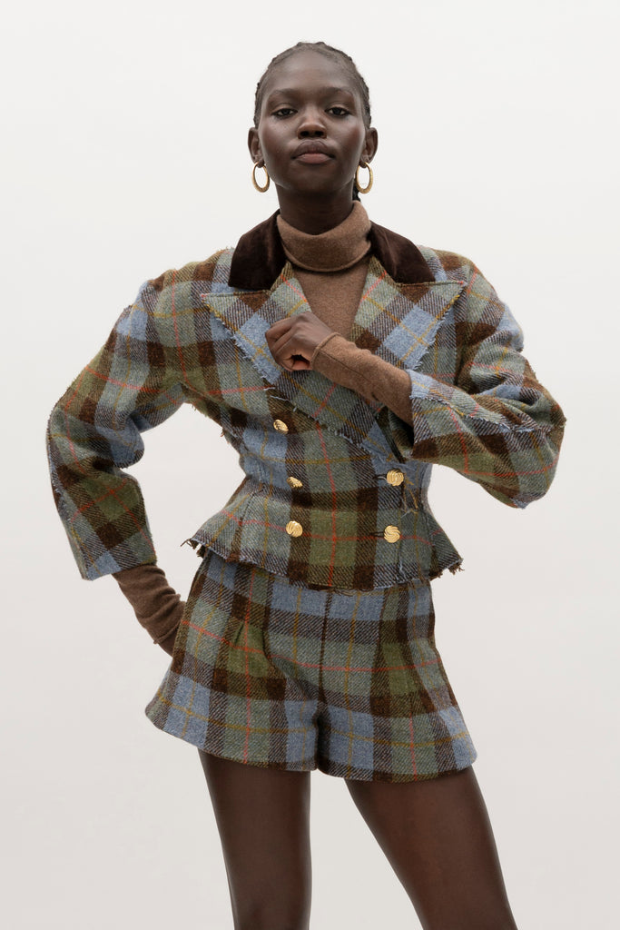 Green Multi Plaid Kate Short Sophisticated and heritage-inspired bottoms, crafted from authentic Harris Tweed, featuring unique textural details.-100% British wool, handwoven in the Western Isles of Scotland-Fully lined-High-waisted paper bag shorts -On-seam pockets-Pleated front-Hidden side zip-Belt loops at back only, designed to keep your belt in place♻️ Minimizing our environmental impact: Harris Tweed is naturally renewable, biodegradable and recyclable.We recommend ordering your usual size.Styled with the Raymond Jacket & Olivia Turtleneck 