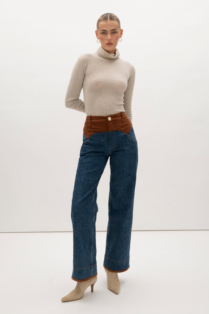 Medium Indigo Torrey Jean Featuring combination fabrics and crafted from premium Japanese denim, these novelty pants elevate the classic wide-leg silhouette with unexpected details.-Premium Japanese denim -Signature corset style waistband in contrasting corduroy fabric -Wide leg-Flannel-lined at waist -Corduroy faced cuffs at bottom hem -Pockets at front and back-Gold knot button closure -Zip-fly ♻️ Environmentally conscious: Made with up-cycled Japanese denim that is produced with reduced CO2 emissions and water-conserving processes. We recommend ordering your usual size.Styled with the Torrey Jacket & Olivia Turtleneck 