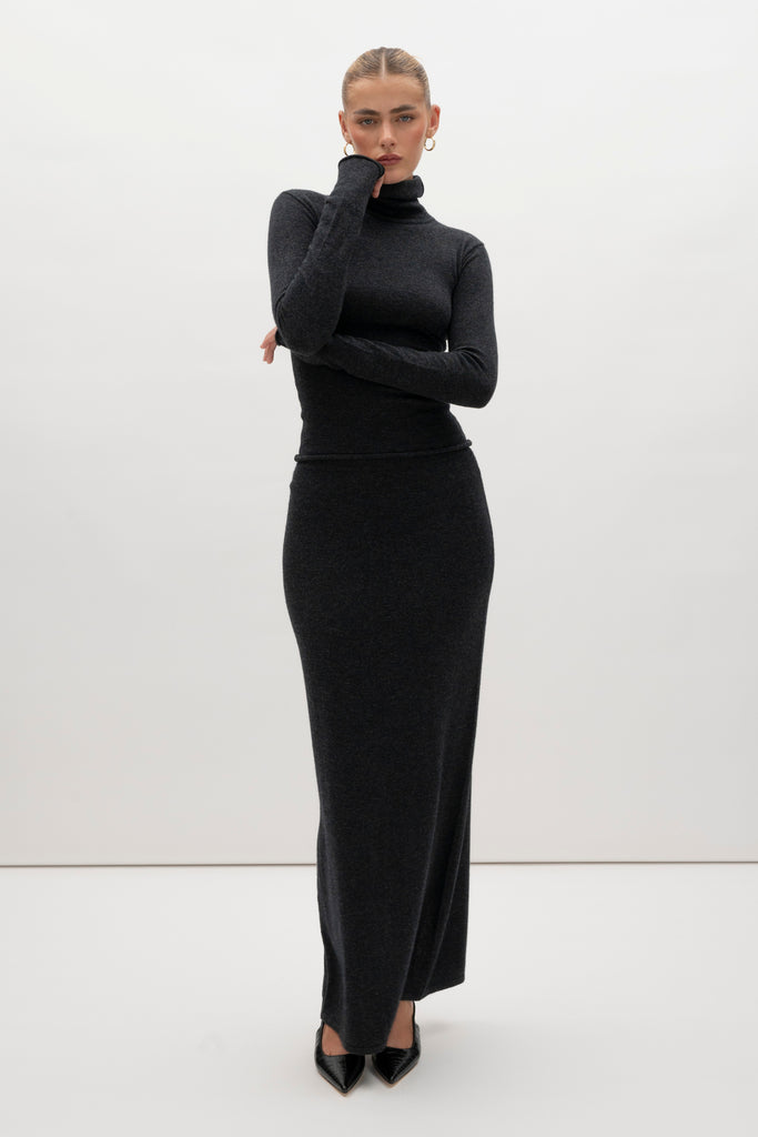 Charcoal Ava Skirt Delicately soft and consciously crafted, the perfect foundation for creating effortless looks.-Classic maxi skirt silhouette-Full length-Slit at center back-Elastic waistband 🐑 Made with Good Cashmere Standard® wool to support the welfare of cashmere goatsWe recommend ordering your usual size.Styled with the Olivia Turtleneck