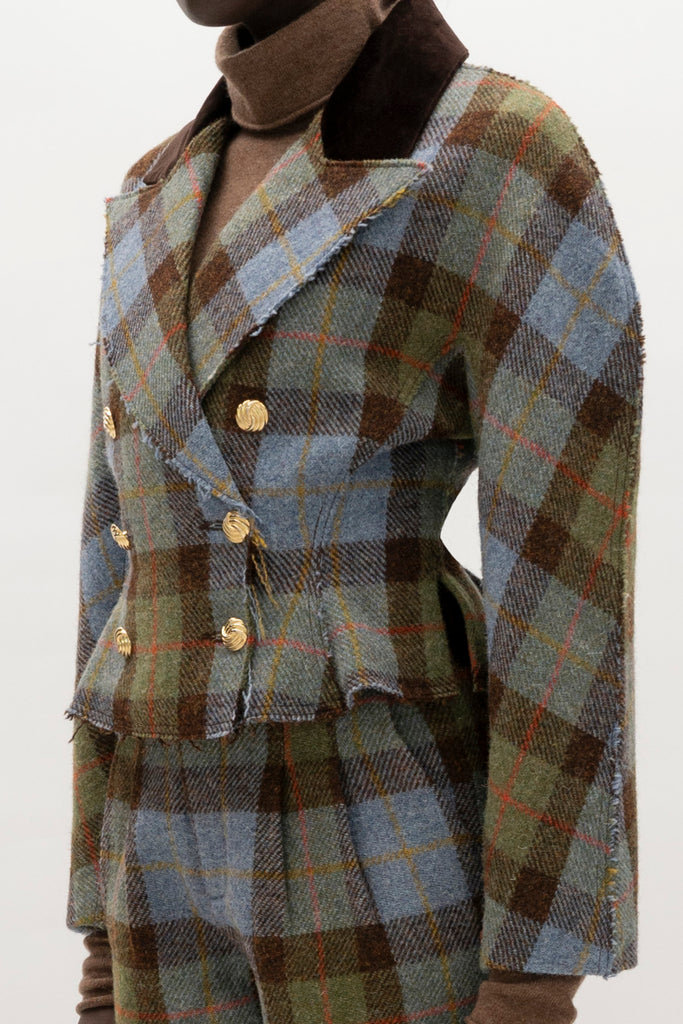 Green Multi Plaid Raymond Jacket A sophisticated and heritage-inspired piece crafted from authentic Harris Tweed, featuring a distinctive double-breasted design and unique textural details.-100% British wool, handwoven in the Western Isles of Scotland-High performance durable and windproof fabric-Double-breasted front closure-Peplum waist detail-Dolman sleeves-Brown velvet contrasting collar-Raw edges at lapel and center front placket-Decorative gold knot button closure-Fully lined♻️ Minimizing our environmental impact: Harris Tweed is naturally renewable, biodegradable and recyclable.We recommend ordering your usual size.Styled with the Raymond Trouser, Kate Short, & Olivia Turtleneck 