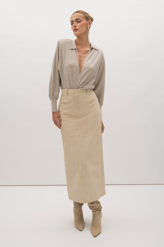 Sand Meredith Skirt -Vintage inspired pencil skirt, fitted through waist and hips-100% calf leather (suede) -Darts at front and back for a sculpted fit-Clean-finished waistband with interior facing and under-stitching-Invisible side zipper with ornate button closure at waistband-Self-doubled belt loops reinforced with strong bar tacks-Back vent for movement -Fully linedWe recommend ordering your usual size.Styled with the Hyde Jacket
