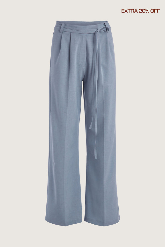 Stone Blue Kat Trouser Dual pleated mid-rise trousers featuring a straight, relaxed fit. Pockets at back with horn buttons. Includes a self-fabric detachable belt. Ana is 5’9