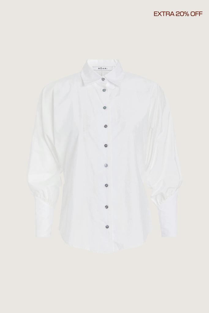  Marna Poplin Shirt -Cotton button front shirt with dolman sleeves-Structured collar with edge stitching for a refined finish-Tailored cuffs with invisible zippers at the back for a sleek detail-Removable self-covered shoulder pads for optional structure-Finished with 2