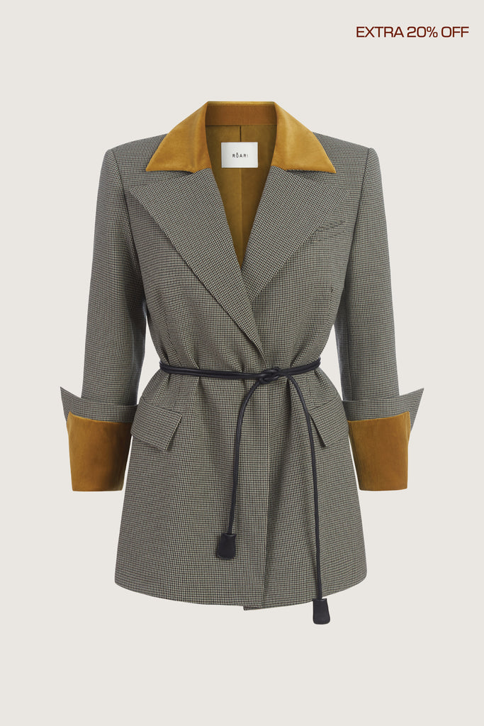  Meredith Blazer This houndstooth blazer is highlighted with contrasting velvet details at the collar and cuffs, providing multiple styling possibilities. It includes a 100% lambskin wrap belt and features a center back vent for added comfort.Molly is 5'9