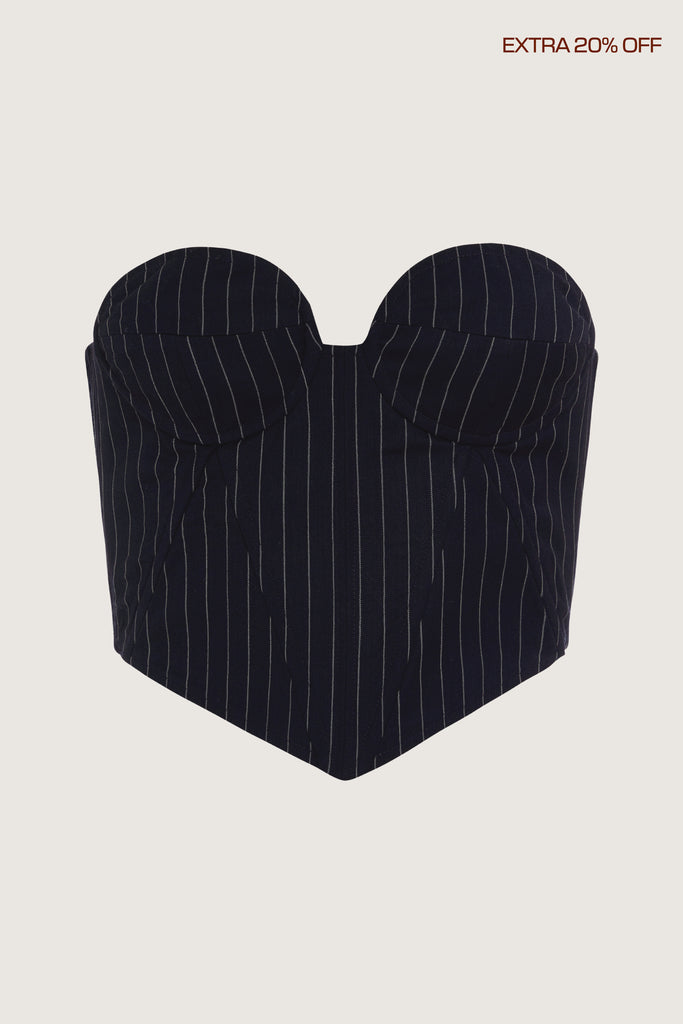 Navy Pinstripe Ronnie Corset This tailored strapless corset features a fitted suiting bodice with contoured boning, moldable wiring at cups, and shirred back panels to ensure a snug yet flexible fit. Slightly cropped with a v-front silhouette.Ana is 5'9