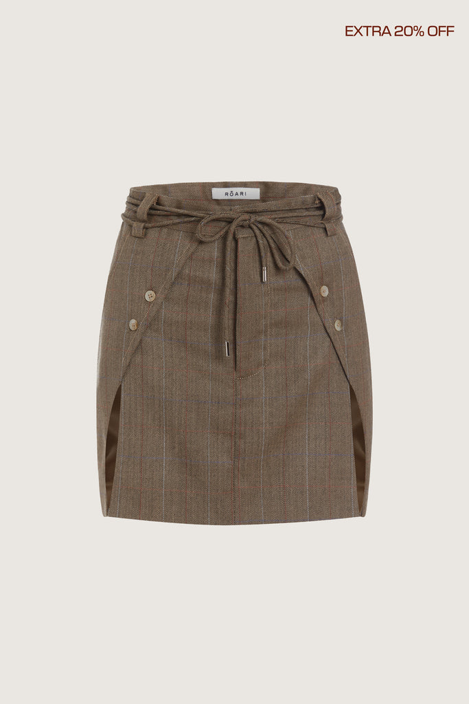 Camel Herringbone Ronnie Skirt Paneled skirt featuring a self-fabric waist tie tunneled through two rows of belt loops. Double front vents are secured by horn buttons. Slightly lengthened back for added coverage.Fits true to sizeStyle with The Ronnie Blazer | The Ronnie Corset*FINAL SALE. Please reference our return & exchange policy here. Extra 20% off auto-applied in cart.
