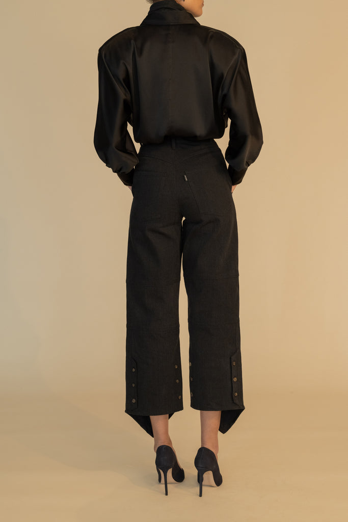 Black MARNA SHIRT A silky button down featuring blouson sleeves. Composed of wrinkle resistant vegan silk, this top includes mother of pearl buttons, concealed zippers at wrists, and removable shoulder pads.  