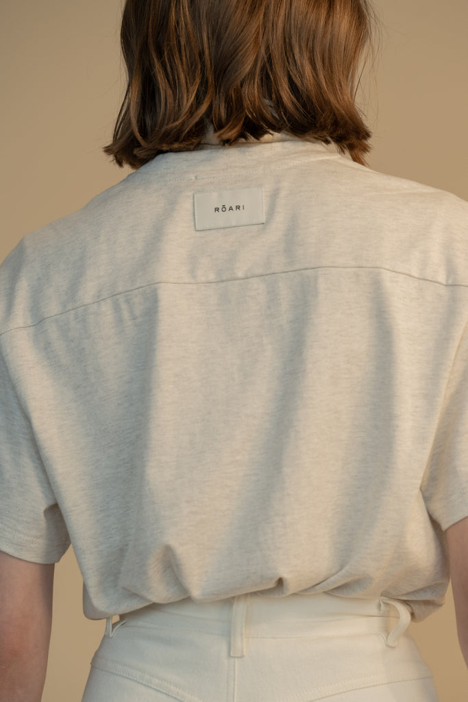 Light Grey DANNY TEE An oversized drop shoulder t-shirt made from 100% lightweight cotton featuring a silk RŌARI branded patch at back of neck. Cut with a boxy fit.Light Grey Danny Tee styled with the Penny Bodysuit. 