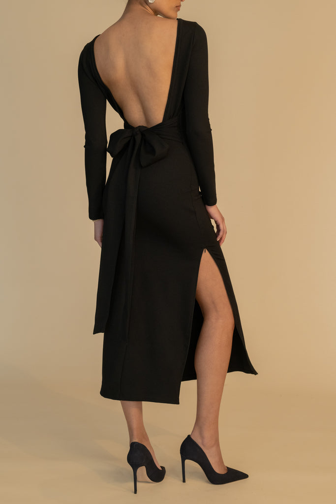 Black BAMBI DRESS This wrap dress features a fixed belt at waist and plunging open back. Crafted from a stretch ponte fabric, hidden zips at sides provide option to vent. Size down for a snug fit.Also available in Bone & Lime Punch featured in Collection 1.