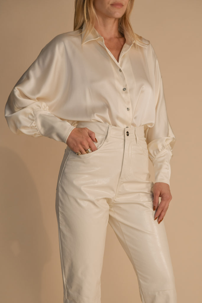 Bone MARNA SHIRT A silky button down featuring blouson sleeves. Composed of wrinkle resistant vegan silk, this top includes mother of pearl buttons, concealed zippers at wrists, and removable shoulder pads.  