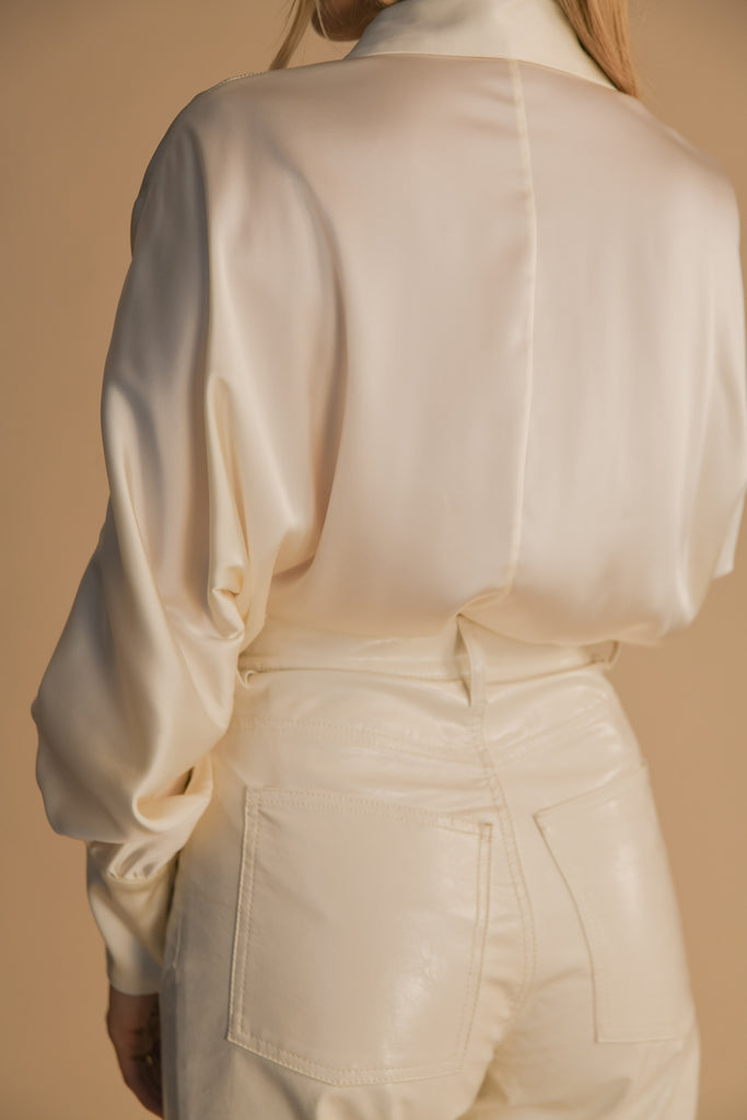 Bone Marna Shirt A silky button down featuring blouson sleeves. Composed of wrinkle resistant vegan silk, this top includes mother of pearl buttons, concealed zippers at wrists, and removable shoulder pads.  