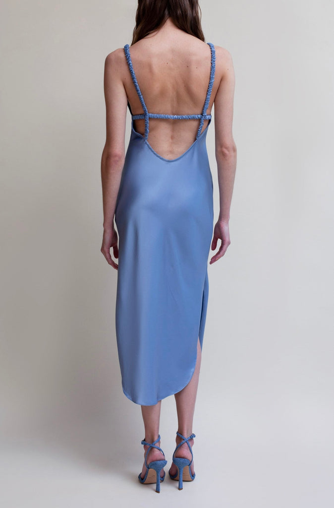 Sky PARAS DRESS The Paras vegan silk midi slip dress features a v-neckline with scalloped trim, bust darts, ruched elastic straps, a low cut open back, and a curved, vented hemline.*All sale merchandise is exchangeable for size only.