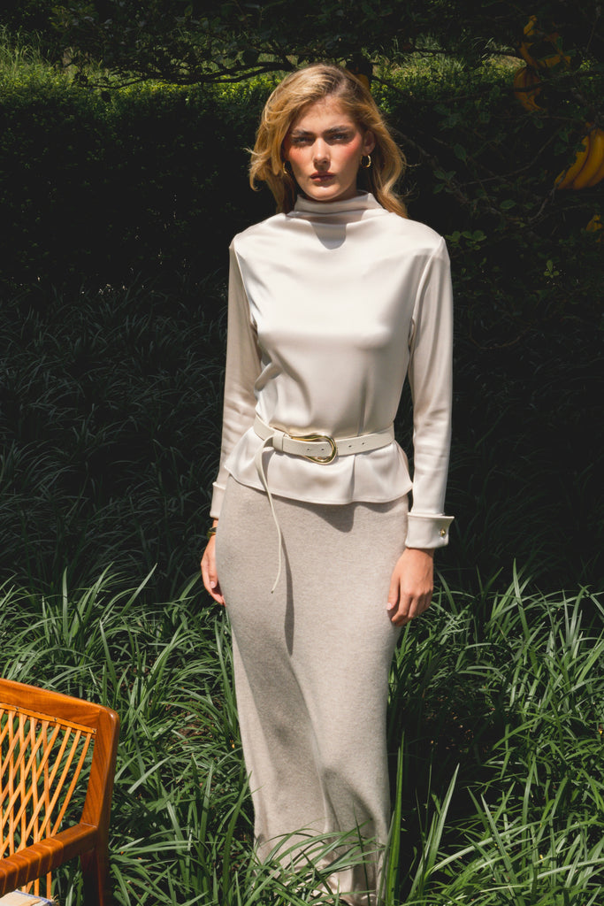 Champagne Vivien LS Top Elevate your wardrobe with this silky-soft and versatile satin top.-Cowl neckline with stacked collar-Self-loops with gold knot buttons at back neck-Removable shoulder pads with interior pockets-Hidden zip at back-Turnback cuff with gold knot button-Fluid drape with tailored structure-Finished with French seamsWe recommend ordering your usual size.Styled with the Vivien Pant & Ava Skirt
