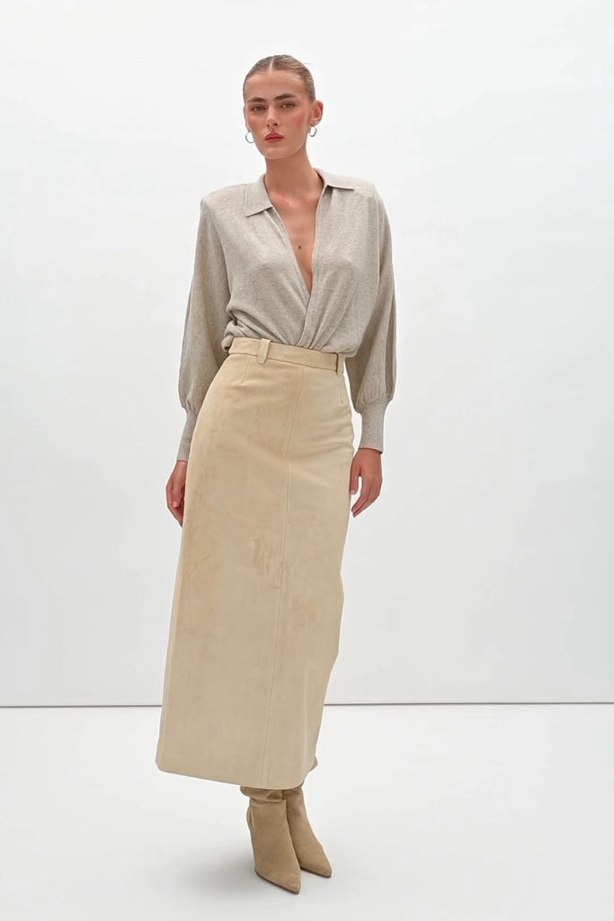 Sand Meredith Skirt -Vintage inspired pencil skirt, fitted through waist and hips-100% calf leather (suede) -Darts at front and back for a sculpted fit-Clean-finished waistband with interior facing and under-stitching-Invisible side zipper with ornate button closure at waistband-Self-doubled belt loops reinforced with strong bar tacks-Back vent for movement -Fully linedWe recommend ordering your usual size.Styled with the Hyde Jacket