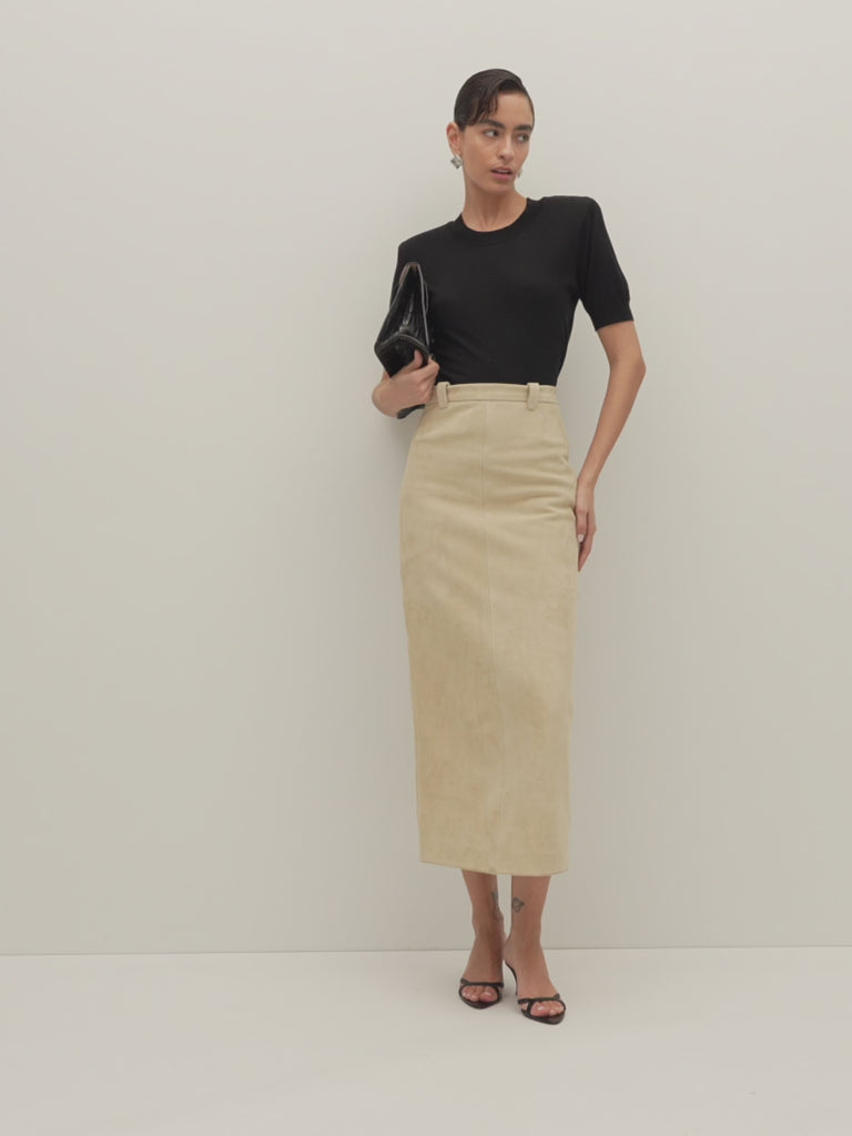 Sand Meredith Skirt -Vintage inspired pencil skirt, fitted through waist and hips-100% calf leather (suede) -Darts at front and back for a sculpted fit-Clean-finished waistband with interior facing and under-stitching-Invisible side zipper with ornate button closure at waistband-Self-doubled belt loops reinforced with strong bar tacks-Back vent for movement -Fully lined Ingryd is 5'10