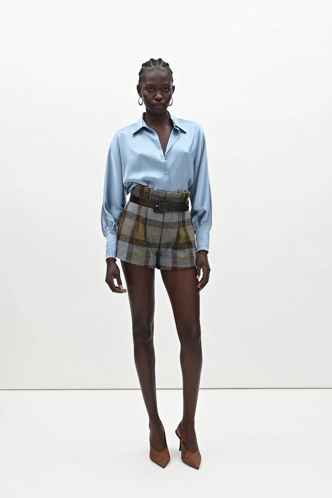 Sky Marna Shirt -Satin button front shirt with dolman sleeves-Structured collar with top and bottom edge stitching-Tailored cuffs with invisible side zippers-Removable self-covered shoulder pads-Finished with refined interior details and minimal visible stitching-Mother of pearl buttons-Wrinkle-resistant recycled satin We recommend ordering your usual size.Styled with the Kate Short