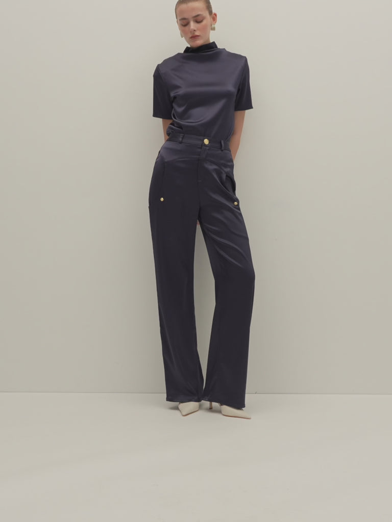 Navy Vivien Top -Cowl neckline with stacked collar-Self-loop and gold knot button at back neck-Removable shoulder pads with interior pockets-French seams for clean finish-1/4” baby hem on sleeves and body-Fluid drape with tailored structure Cara is 5'10