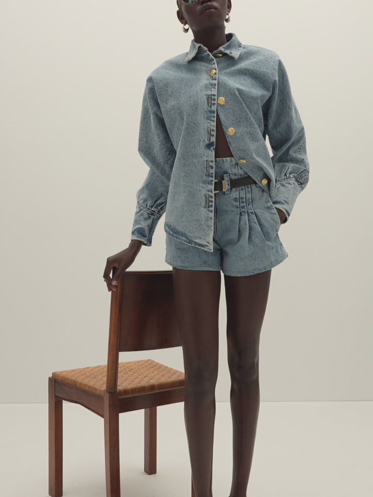 Light Indigo Kate Short -High-waisted paperbag fit-Curved hem to elongate legs-Stitched pleats at waistband-Reinforced denim belt loops-Zipper closure with clean finish-V-notch at back waist-On-seam pockets with contrast lining-Self-facing waistband with under-stitching-Overlocked interior seams-Garment custom washed for a lived-in feel Anok is 5'9