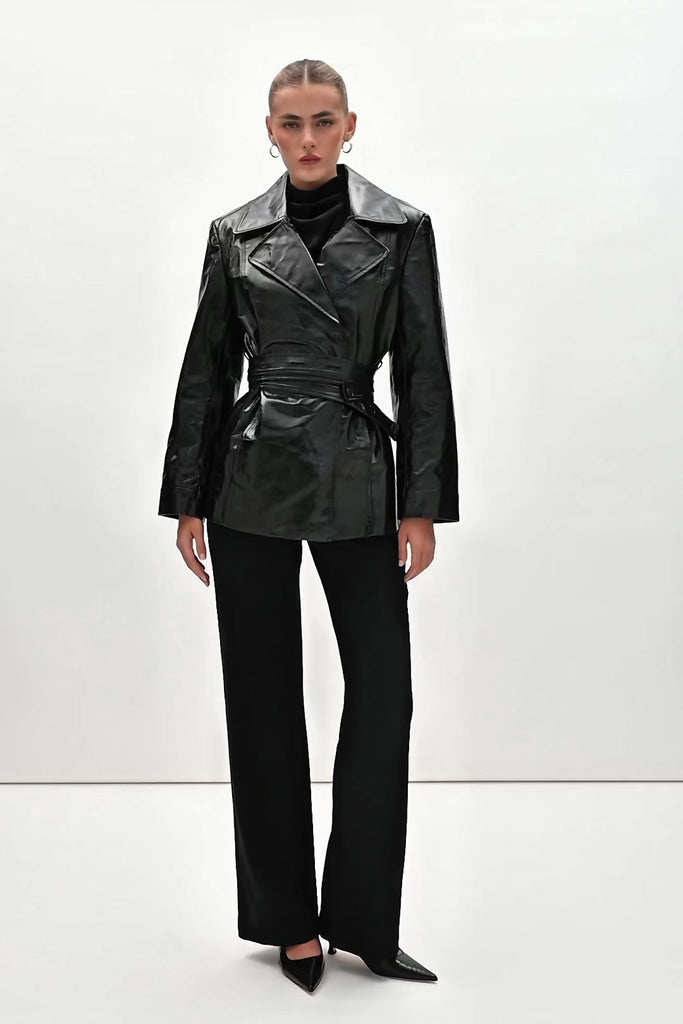 Black Kennedy Trench Crafted from 100% glazed cow leather, the Kennedy trench showcases sharp collars and clean lines. The cinched waist with buttoned belt offers a customizable fit.-100% glazed cow leather trench -Hidden stay button closure-Double wrap belt-Bracelet-length sleeve-On seam front pockets-Fully lined Handcrafted in small batches by our expert leather artisan in New York City.We recommend sizing up if a relaxed fit is desired otherwise choose your usual size.Styled with the Vivien LS Top & Mia Trouser