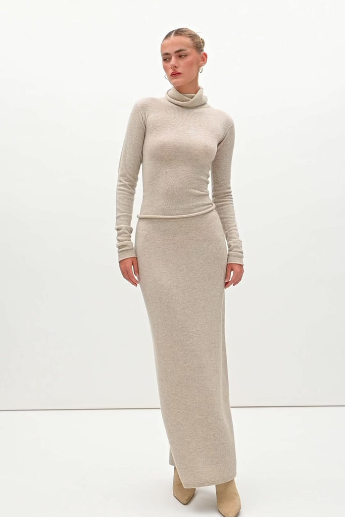 Oatmeal Ava Skirt Delicately soft and consciously crafted, the perfect foundation for creating effortless looks.-Classic maxi skirt silhouette-Full length-Slit at center back-Elastic waistband 🐑 Made with Good Cashmere Standard® wool to support the welfare of cashmere goats We recommend ordering your usual size.Styled with the Olivia Turtleneck & Vivien LS Top