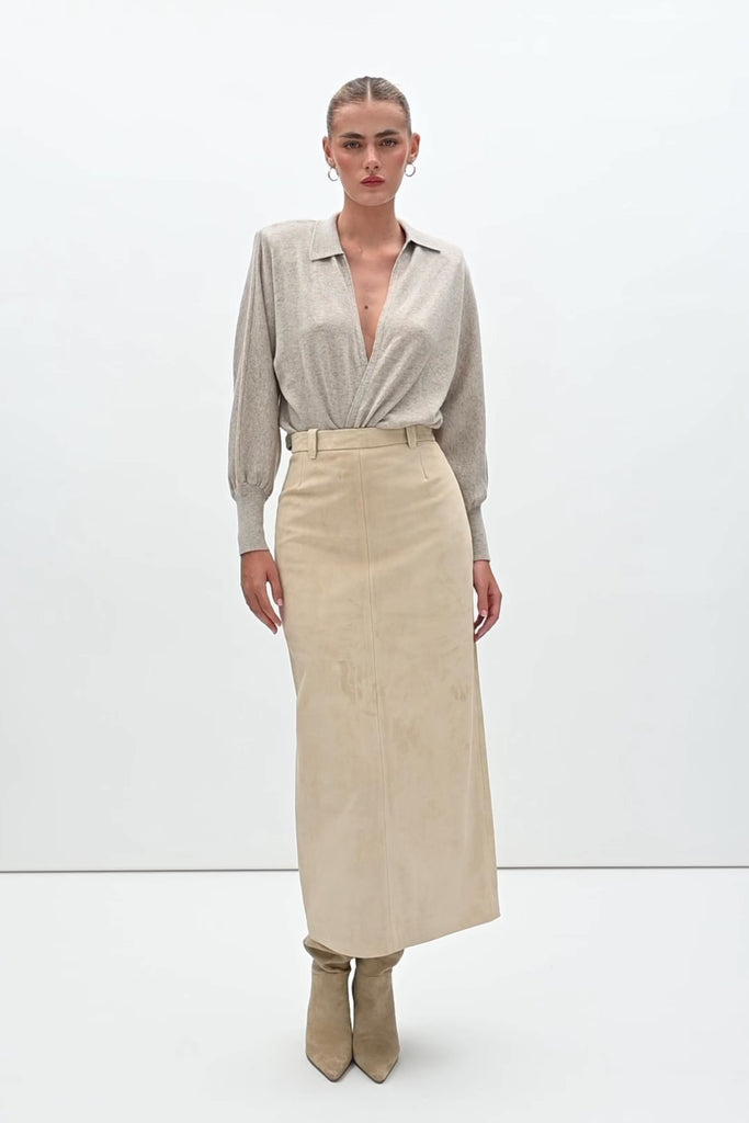 Sand Meredith Skirt -Vintage inspired pencil skirt, fitted through waist and hips-100% calf leather (suede) -Darts at front and back for a sculpted fit-Clean-finished waistband with interior facing and under-stitching-Invisible side zipper with ornate button closure at waistband-Self-doubled belt loops reinforced with strong bar tacks-Back vent for movement -Fully linedWe recommend ordering your usual size.Styled with the Hyde Jacket