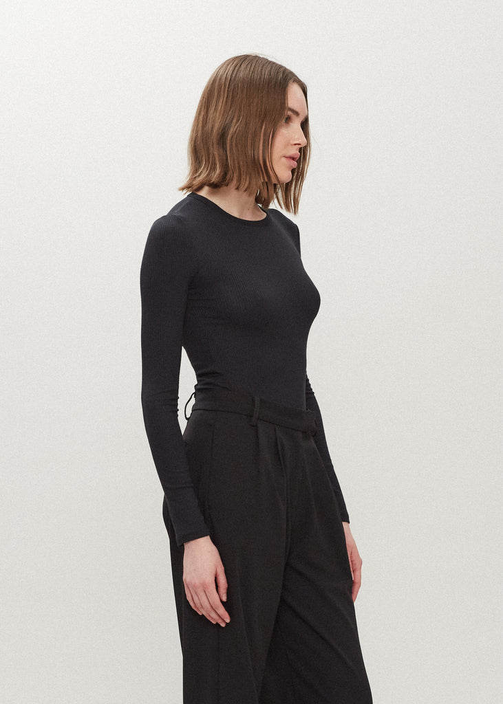 Black Baby Bodysuit This buttery soft long sleeved bodysuit features a sleek silhouette with a crew neckline and an asymmetrical bold back cutout. *For sanitary reasons, bodysuits are finale sale.