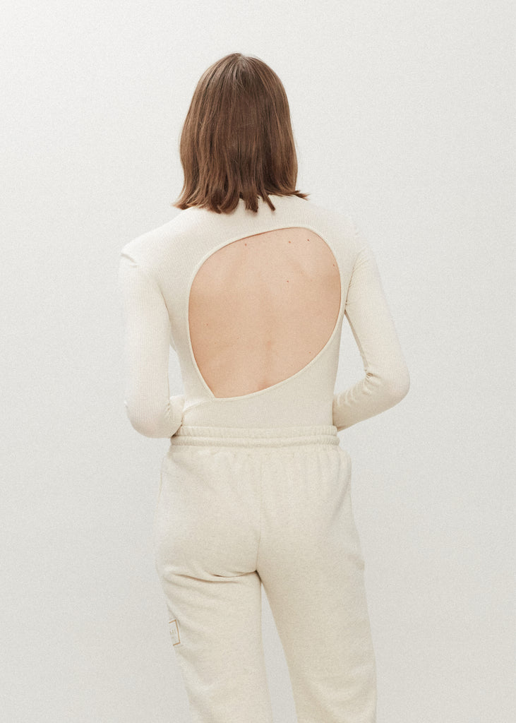 Bone Baby Bodysuit This buttery soft long sleeved bodysuit features a sleek silhouette with a crew neckline and an asymmetrical bold back cutout. *For sanitary reasons, bodysuits are finale sale.